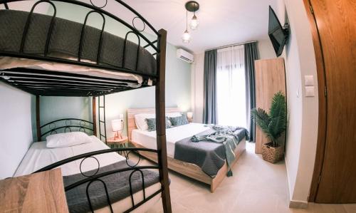 a bedroom with two bunk beds and a balcony at Bloom Garden Apartments in Ierissos