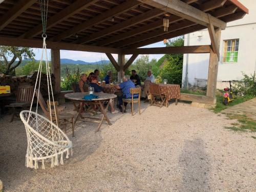 a group of people sitting at a table under a pavilion at Nostalgická myš in Kokořín