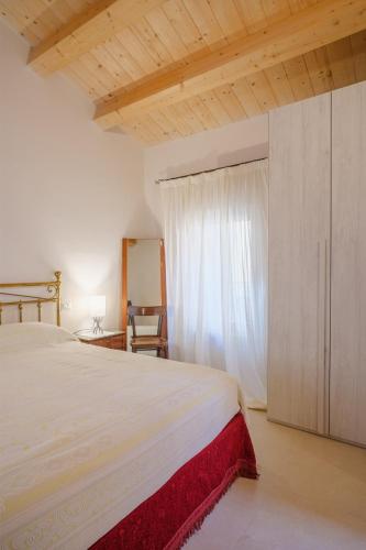 a bedroom with a large bed and a window at La Casa di Vina in Fermo