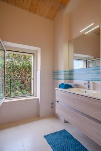 a bathroom with a sink and a window at La Casa di Vina in Fermo