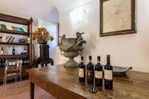 a group of wine bottles on a wooden table at Castello di Volpaia in Radda in Chianti
