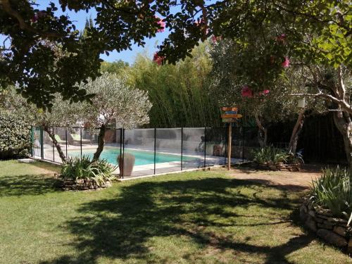 une clôture autour d'une piscine dans une cour dans l'établissement Les treilles de Provence, Gîte Le muscat, à Villeneuve-lès-Avignon