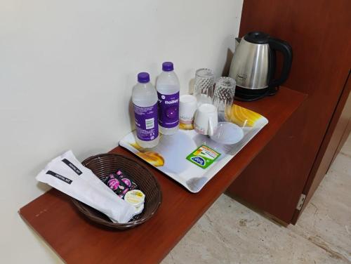 a table with bottles of water and other items on it at The Paradise Guest Inn in Nellore