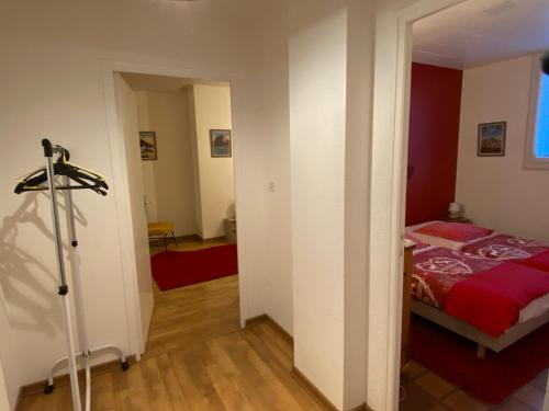 a bedroom with a bed with a red blanket at Les Apparts de la Tourronde in Chorges