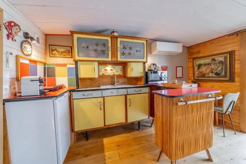 a kitchen with yellow cabinets and a red counter top at Superbe Péniche En Centre Ville in Bordeaux