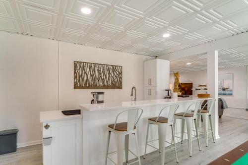 a kitchen with a white counter and stools at Fall Escape on Lookout Shoals Lake with Game Room! in Sharon