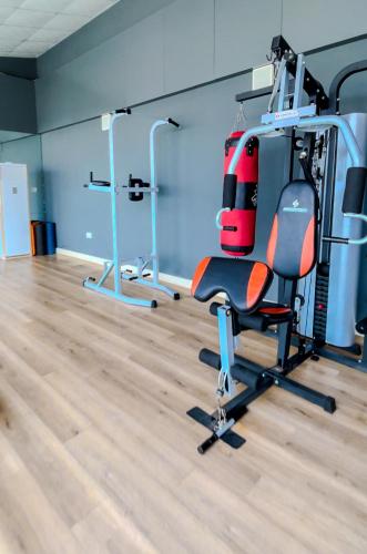 a room with a gym with a chair and exercise equipment at Farath Smart Apartment in Lagos
