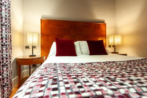 a hotel room with a bed and two lamps at Hotel Delle Nazioni in Rome