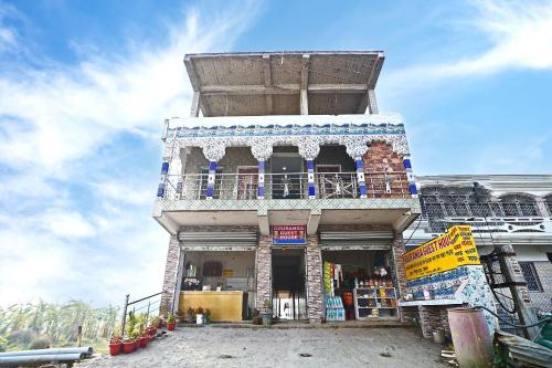 a building with a balcony on the side of it at Gouranga Guest House Mayapur ISKCON 300 MTS in mayapur
