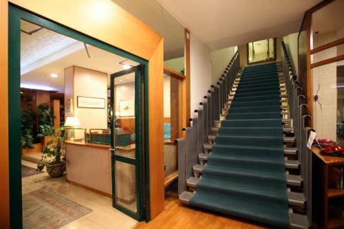 a staircase in a house with a glass door at Hotel Cristallo in Udine