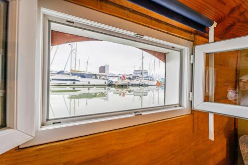 a window in a room with a view of a marina at Superbe Péniche En Centre Ville in Bordeaux