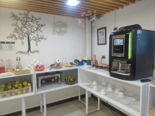 a kitchen with a counter with a microwave and fruit at Hotel Boutique Quinta Camacho in Bogotá