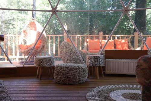 a porch with swings and a hammock on a deck at Le Hameau Arribas in Condé-Sainte-Libiaire