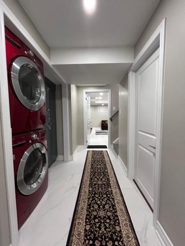 a hallway with two washing machines and a carpet at Private 2bedroom Unit, Free Parking, Free from Smoke & Pet, Self-Check IN in Pickering