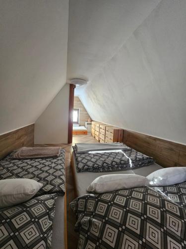 a room with two beds in a attic at JIROTOVY BOUDY II in Telnice