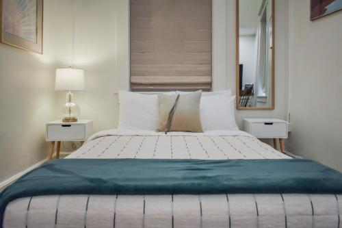 a bedroom with a large bed with white pillows at Warner Hotel in Bisbee
