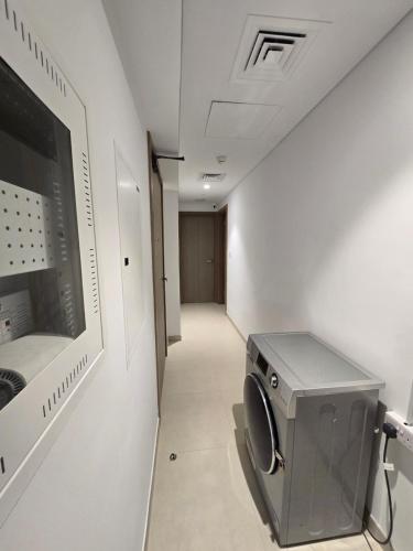 a hallway with a washing machine in a room at Oshare Modern Living Dubai by Shiro Elegant Holiday Homes in Dubai