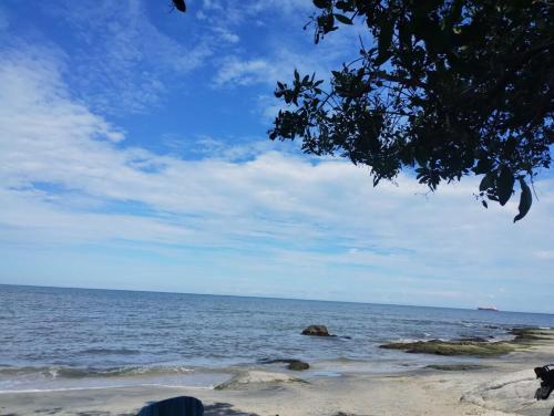 a view of the ocean with rocks on the beach at Aparta suite en Santa Marta in Santa Marta