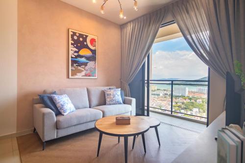 a living room with a couch and a table at Iconic Regency by Stellar ALV in Bayan Lepas