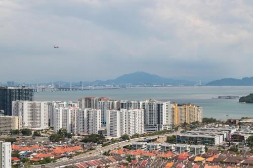 an aerial view of a city with buildings and the water at Iconic Regency by Stellar ALV in Bayan Lepas