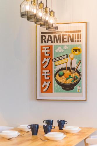 a picture of ramen on the wall above a table at Iconic Regency by Stellar ALV in Bayan Lepas