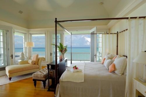 a bedroom with a bed with a view of the ocean at Blessed to Dream Villas in Long Bay Village