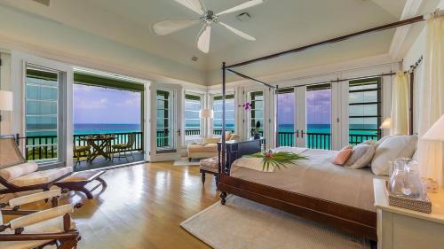 a bedroom with a bed with a view of the ocean at Blessed to Dream Villas in Long Bay Village