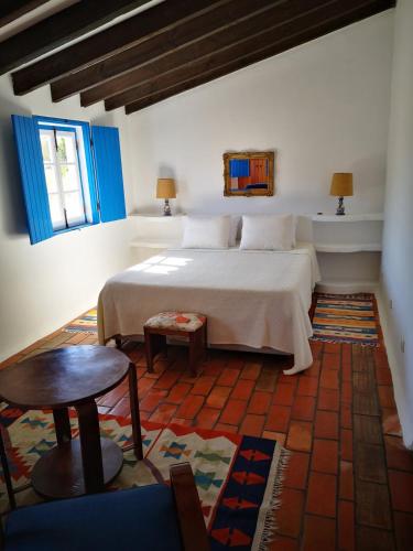 En eller flere senge i et værelse på Monte da Pereira - Casa Rural em Espaço Tranquilo