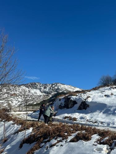 two people walking down a snow covered hill at VILA DISHA in Tirana