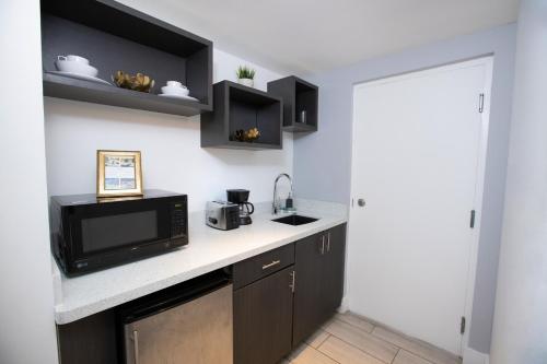 a kitchen with a microwave oven and a counter top at Waterside Hotel and Suites in Miami Beach