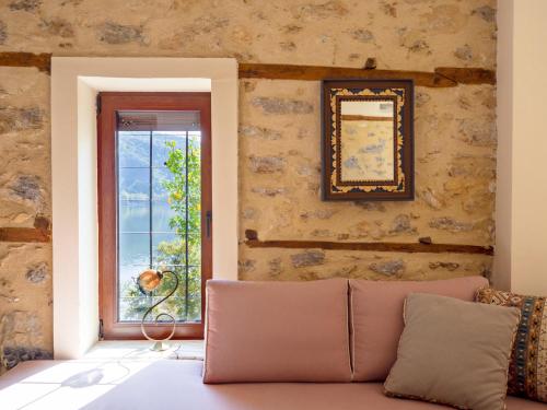 a living room with a couch and a window at Beautiful house with garden and amazing lake view in Kastoria