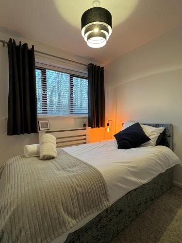 a bedroom with a large bed and a window at Mill Croft, Home from Home in Bolton