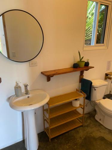 a bathroom with a sink and a mirror and a toilet at Rancho Estero in Santa Catalina