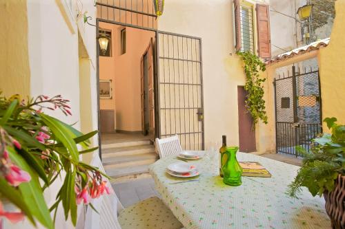 a table with plates and a bottle of wine on a patio at Casa Maria Vittoria in Cannero Riviera