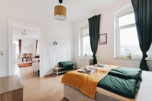 a bedroom with a bed and a living room at Heideblick Apartment Dresden WIFI Netflix in Dresden