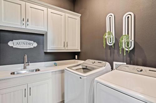 a kitchen with a washer and dryer and a sink at Bear's Den At Reunion Resort-TB024 in Kissimmee