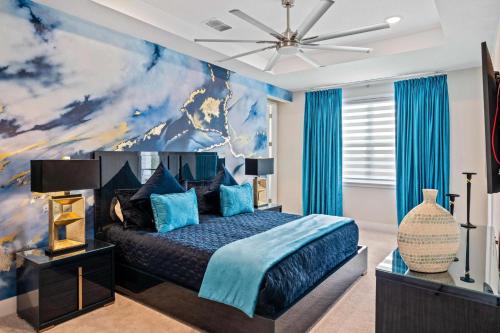 a bedroom with a blue bed with a painting on the wall at Bear's Den At Reunion Resort-TB024 in Kissimmee