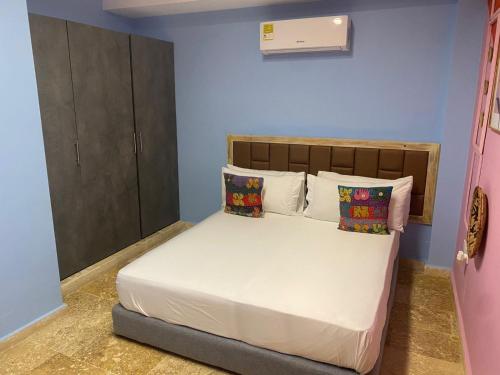 a bedroom with a bed with white sheets and pillows at Coco Beach Cartagena in Cartagena de Indias