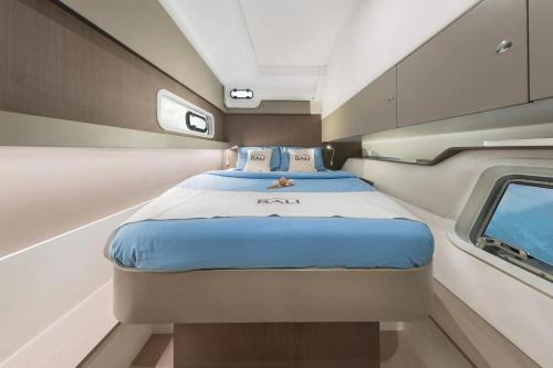 a bed in a small room with a window at Sicily by Catamaran in Palermo