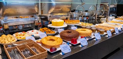 a buffet of cakes and pastries in a bakery at Grande Hotel da Barra in Salvador