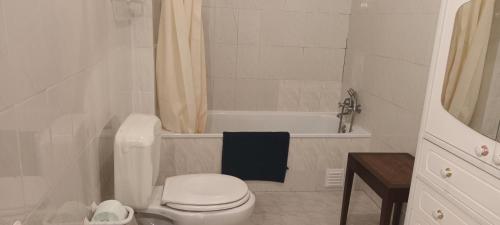 Un baño blanco con inodoro y bañera. en T1 em Alvor, en Alvor