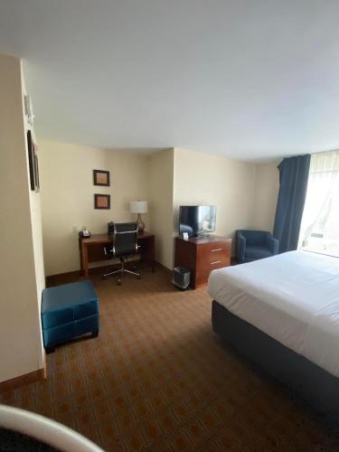 a hotel room with a bed and a desk at Comfort Inn & Suites Brattleboro I-91 in Brattleboro