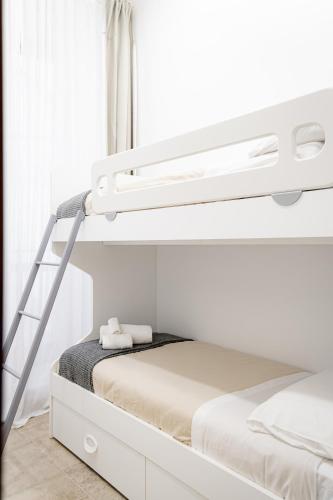 a bedroom with a bunk bed with a ladder at Vetritte Luxury in Bitritto