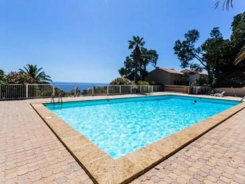 une piscine avec l'océan en arrière-plan dans l'établissement Appartement T2 Mezzanine, Piscine, Parking, Côte d'Azur - FR-1-226B-189, à Rayol-Canadel-sur-Mer