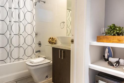 a bathroom with a toilet and a shower at Waterside Hotel and Suites in Miami Beach