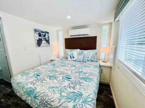 a small bedroom with a bed and a desk at Vacation Cottage North Myrtle Beach #65 in Myrtle Beach