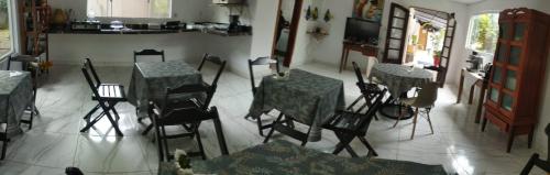 a room with two tables and chairs and a kitchen at Pousada do DIDI in Chapada dos Guimarães