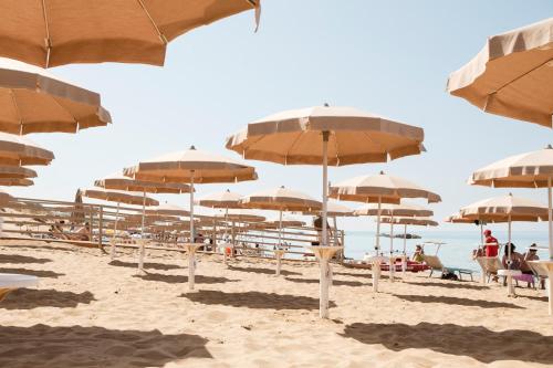 a group of umbrellas on a sandy beach at La Rotta Rooms in Agrigento