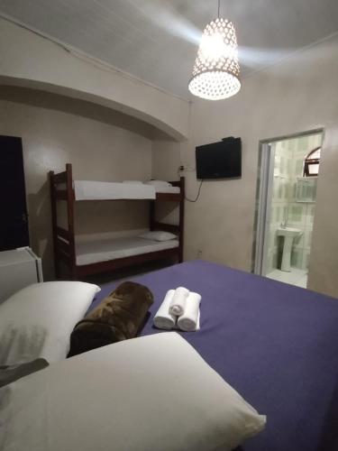 a bedroom with a bed with two pillows on it at Pouso Trindade in Trindade