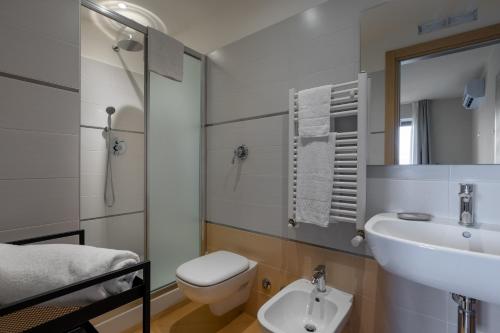 a bathroom with a sink and a toilet at Tuscasì Aparthotel in Sovicille